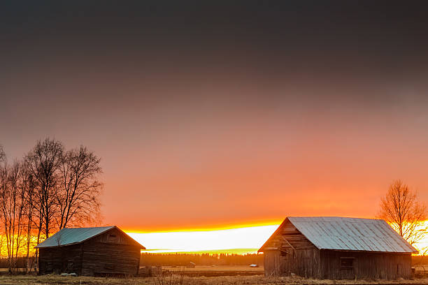 istock Last Rays Of Sun Behind The Barn Houses 472989998