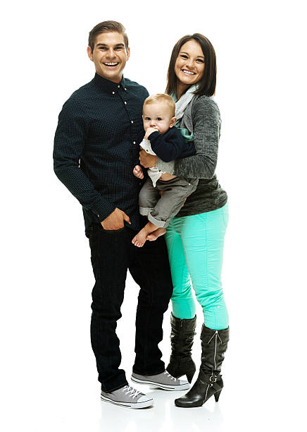 istock Smiling couple standing with their baby 472990522
