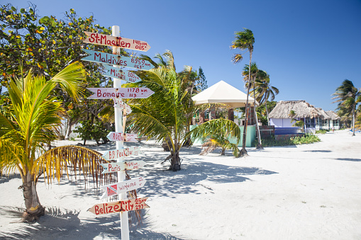 Wooden signs show distances to various destinations around the world from this resort in the Caribbean Sea.