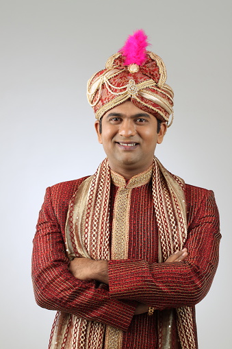 an Indian groom wearing the traditional sherwani attire.