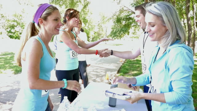 Blonde athletic woman registering for 5k or charity marathon race