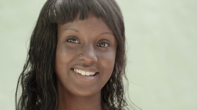 Beautiful black female teen smiling and looking at camera