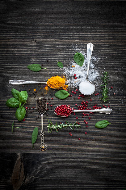 Various spices and fresh herbs at wooden table