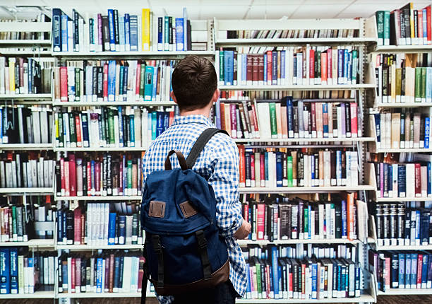 istock Rear view of male student in library 473016424