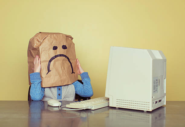 istock Sad Paper Bag Boy is Cyber Bullying Victim 473016564
