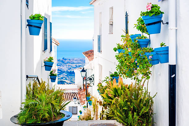 Picturesque street of Mijas Picturesque street of Mijas with flower pots in facades. Andalusian white village. Costa del Sol. Southern Spain andalusia photos stock pictures, royalty-free photos & images