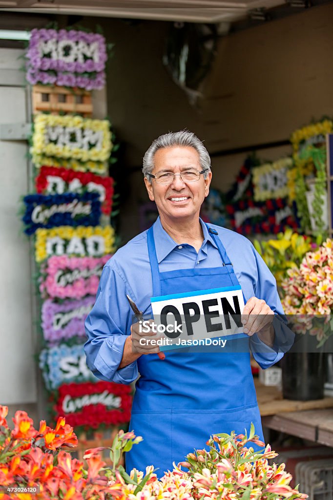 Open for Business: Hispanic Small Business Flower Shop Owner Smiling, handsome, Hispanic small business flower shop owner standing in his outdoor shop Open Sign Stock Photo