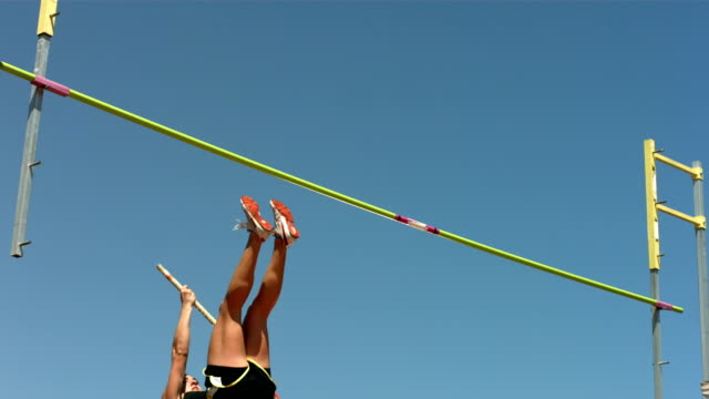 Track and Field athlete doing pole vault, slow motion