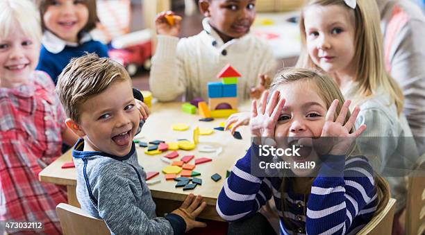 Playful Preschoolers Having Fun Making Faces Stock Photo - Download Image Now - Child, Preschool, Playing