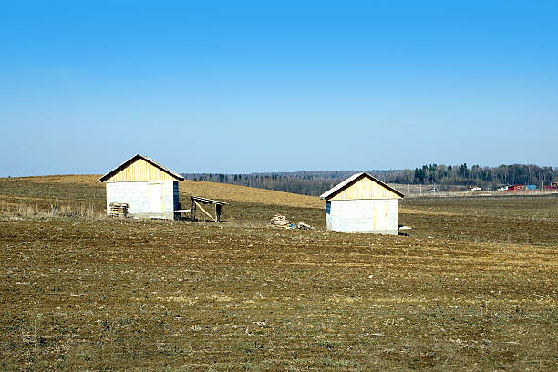 istock Landscape with plowed field with two houses 473034396