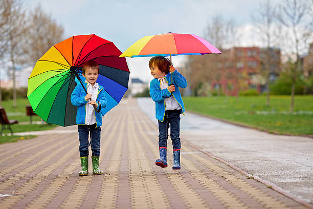 istock Two adorable little boys, walking in a park 473040322