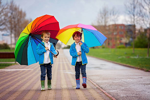 istock Two adorable little boys, walking in a park 473040334