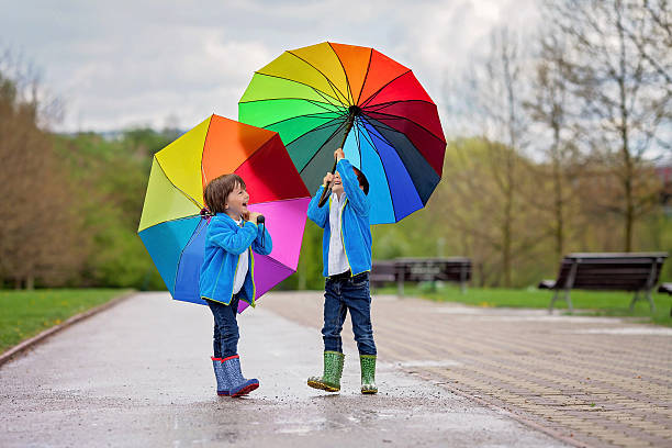 istock Two adorable little boys, walking in a park 473040336