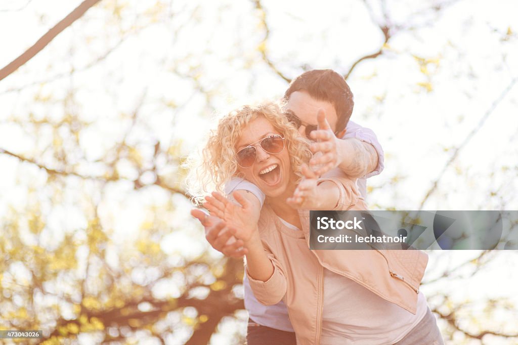 happiness vintage toned portrait of a smiling young happy Caucasian couple in the city park, on the bright, hot summer day. taken with large aperture Canon portrait lens 85mm at f1,8. 20-29 Years Stock Photo