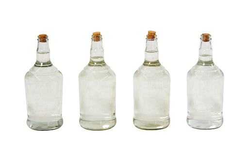 Glass bottles and jars of different shapes and sizes on white background