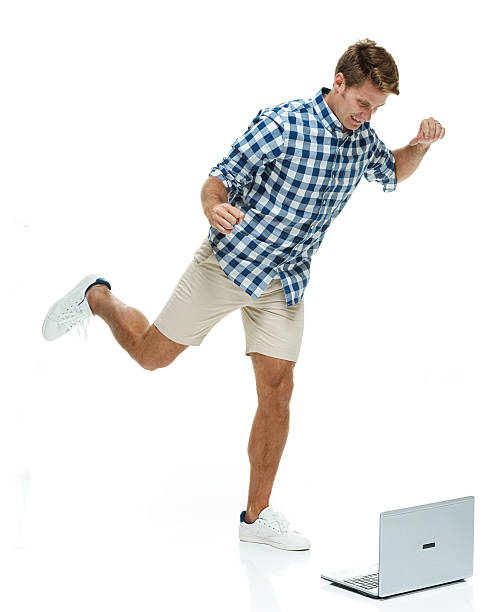 istock Casual man kicking the laptop 473043512