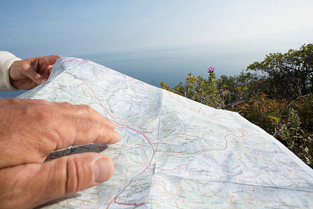 istock Detail of 2 people holding map, planning route ahead 473045954