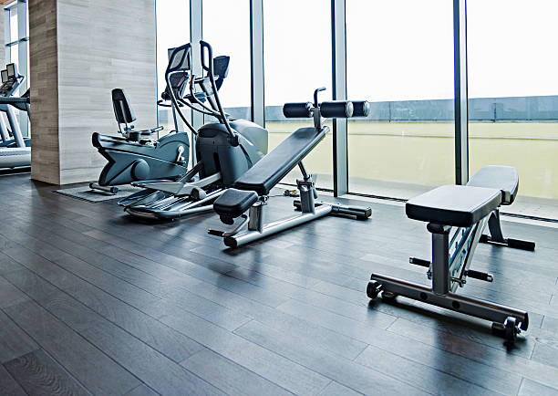 istock Gym equipment in an empty gym with window view 473045982
