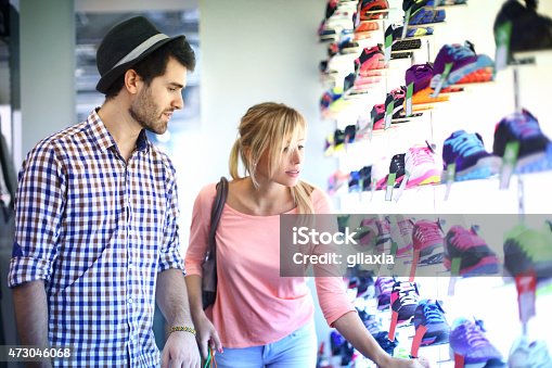 istock Two people buying shoes in retail store. 473046068