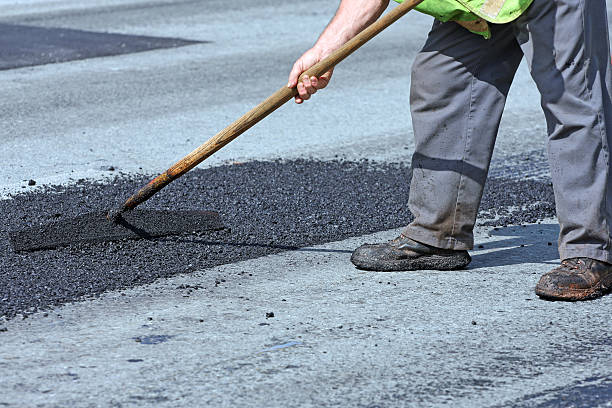 istock Spreading Hot Asphalt On A Pothole Repair Site 473046158
