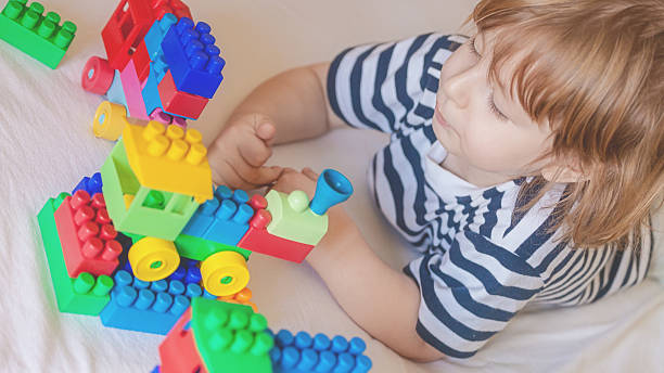 istock little boy playing with toy blocks 473054160