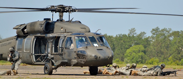 Crestview, USA - May 9, 2015: A Sikorsky UH-60 Blackhawk operated by the Army Rangers lands on a runway in Florida. Soldiers are leaving the helicopter as part of a training exercise.
