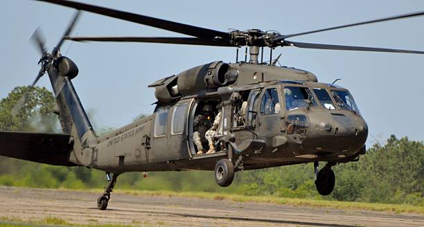 UH-60 Black Hawk Landing Crestview, USA - May 9, 2015: A Sikorsky UH-60 Blackhawk operated by the Army Rangers lands on a runway in Florida. blackhawk stock pictures, royalty-free photos & images