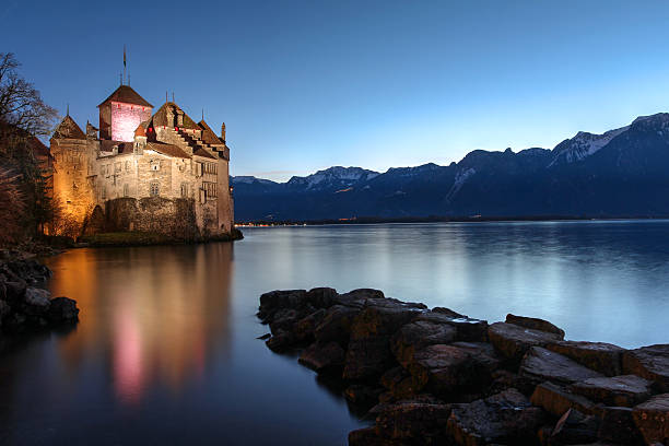 Chillon Castle, Montreux, Switzerland Montreux, Switzerland - January 4, 2015: Chateau de Chillon, Switzerland at sunset time reflecting in the waters of Lake Geneva (Leman) near Montreux. The castle dates from the 12th century and it's the most impossing Swiss castle. chateau de chillon photos stock pictures, royalty-free photos & images