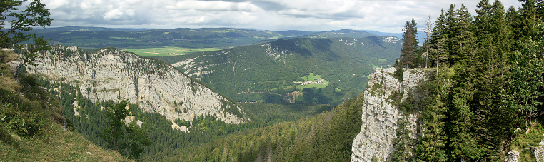 Stitched panorama made of 4 pictures. The Creux du Van is a natural rocky cirque approximately 1,400 metres wide and 150 metres deep, on the north side of Le Soliat.