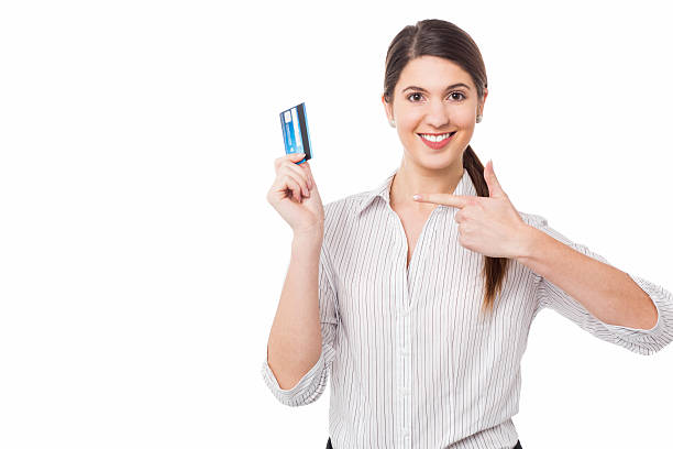 istock Smiling woman indicating towards credit card 473063650