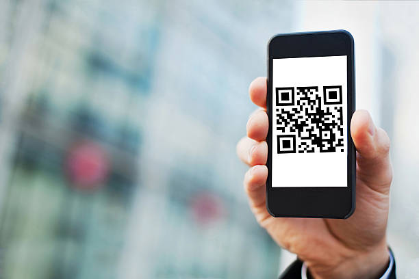 QR code on the screen of smart phone hand holding smartphone with QR code on the screen qr code photos stock pictures, royalty-free photos & images