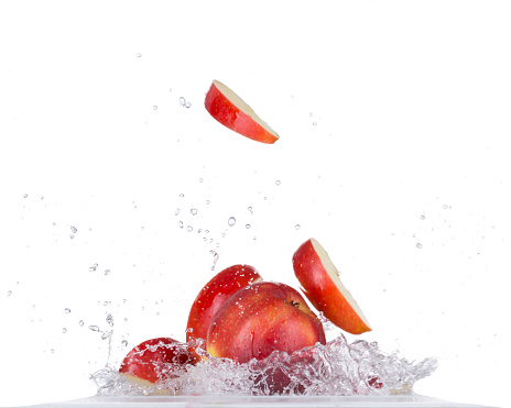 Fresh red apple in water splash isolated on white backround