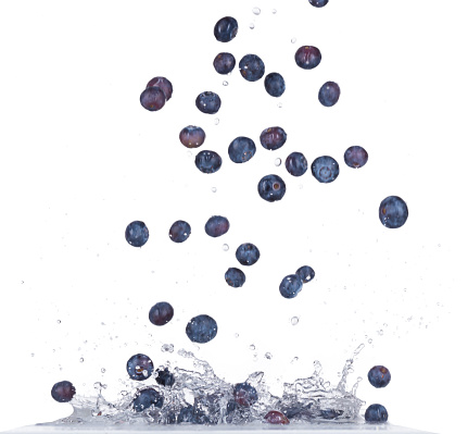 Fresh blueberries in water splash isolated on white background