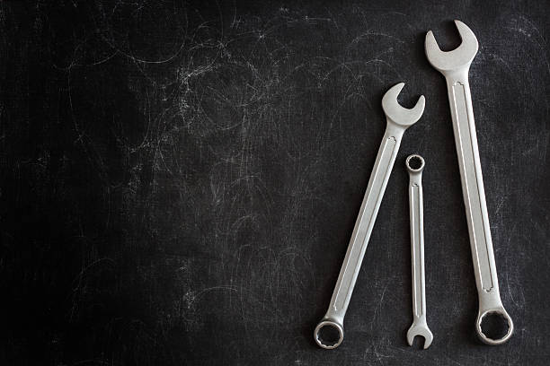 Wrenches on a dark background Set of 3 Wrenches on a Dark Textured Background car instruments stock pictures, royalty-free photos & images