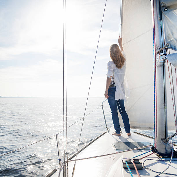 woman staying on sailboat stock photo