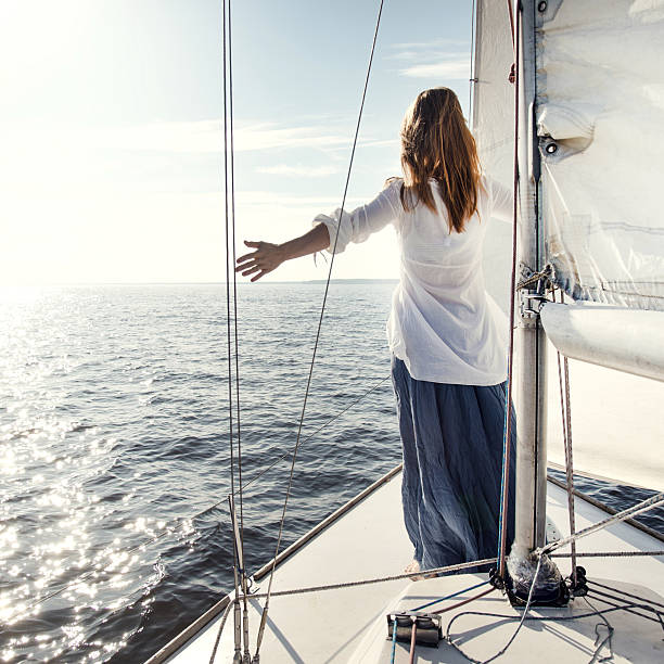 istock woman staying on sailboat 473070558