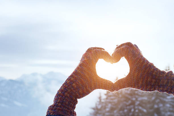 love winter hands in colorful gloves doing heart shape, love winter concept formal glove stock pictures, royalty-free photos & images
