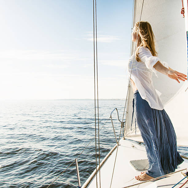 istock woman staying on sailboat 473070700