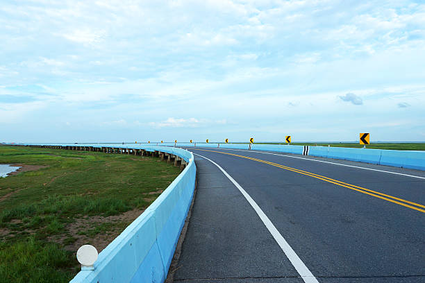 istock Empty road and the yellow traffic lines with clouds. 473070924