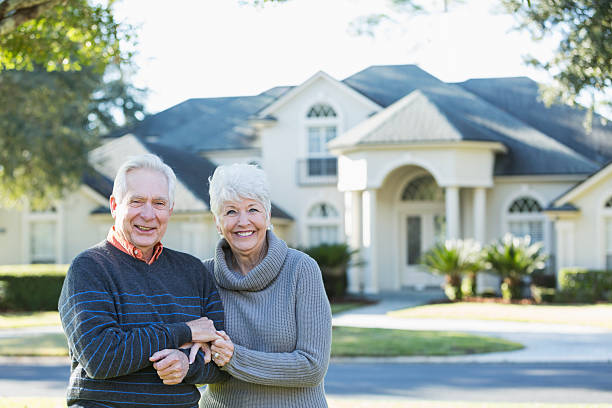 istock Senior couple standing in front of house 473071432