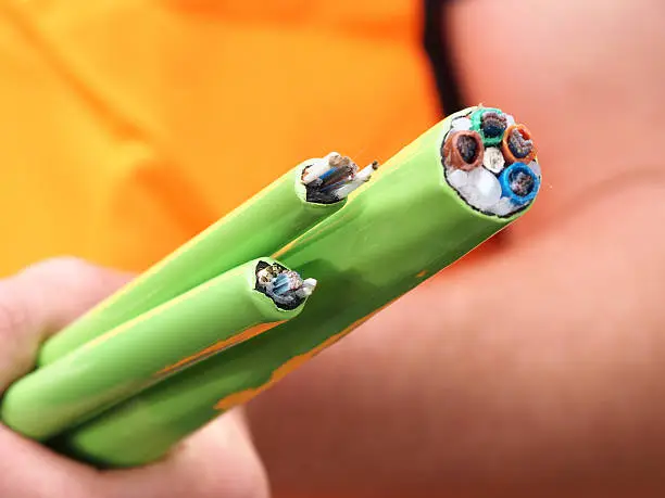 Green Nylon jacketed 576, 144 and 72 fiber optic ribbon cable end used for the National Broadband Network in Australia, a fast internet rollout covering 90% of Australia, held as a bundle typical for a cable duct in Melbourne, Australia