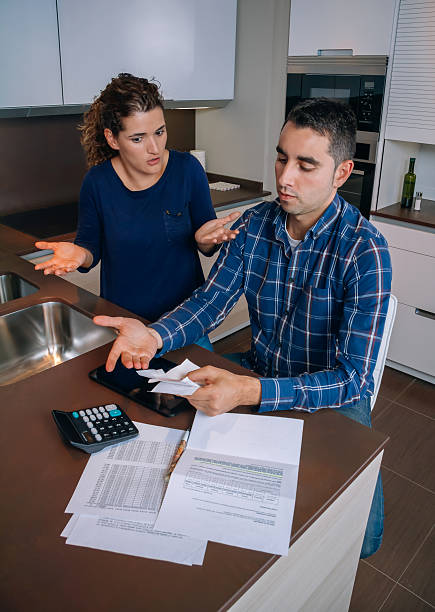 istock Unemployed young couple with debts reviewing their bills 473077376