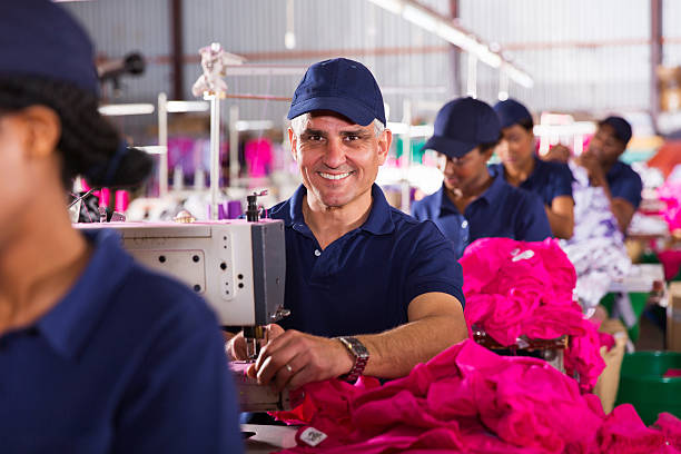 istock middle aged male textile worker sewing in factory 473081406