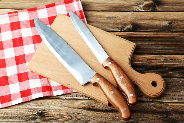 istock Kitchen knifes on brown wooden background 473087972