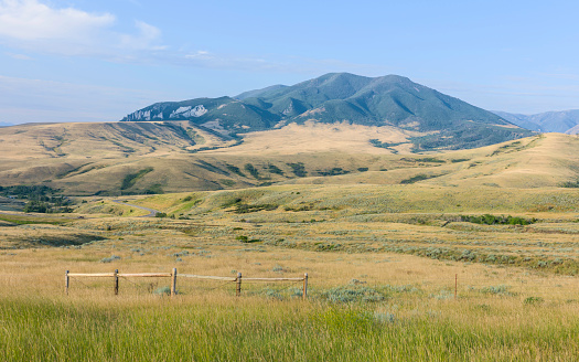 Red Lodge, Montana, USA. Foothills of Bear Tooth Mountains at dawn on a summer day with sagebrush and grassland as viewed from the Bear Tooth Mountain pass highway between Red Lodge and Cooke City, Montana, USA.