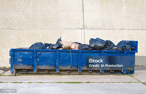 blue-garbage-container-on-the-road.jpg?s