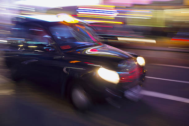 Abstract blurry image of a London taxi cab driving on a street.