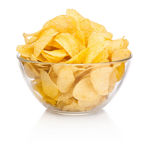 istock Potato chips in glass bowl isolated on white background 473089494