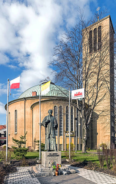 Monument to Father Jerzy Popieluszko Bytom, Poland - April 6, 2015: Monument to Father Jerzy Popieluszko in front of the Church of the Exaltation of the Holy Cross., Father Popieluszko was an opposition activist during communist period, assassinated by communist secret service in 1984,  solidarity labor union stock pictures, royalty-free photos & images