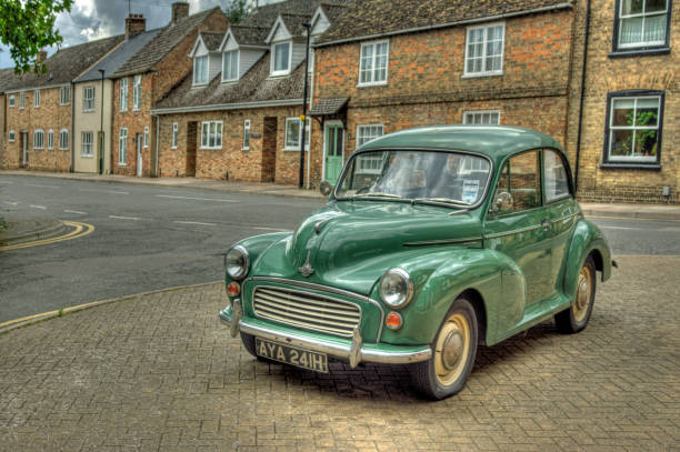Morris Mini Minor saloon Eky, United Kingdom - August 18, 2014: Green Morris Mini Minor 1000 saloon. This is created from 3 bracketed images combined in HDR software and adjusted to give a natural look in Photoshop. The car was situated in Ely, Cambridgeshire.  ely england stock pictures, royalty-free photos & images